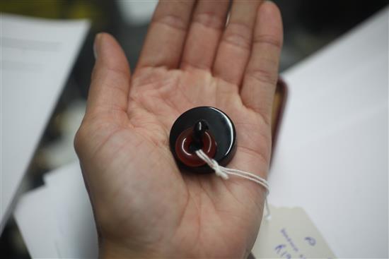 A cased mid 1930s French Cartier silver, black enamel and carnelian plug pill box, 3cm.